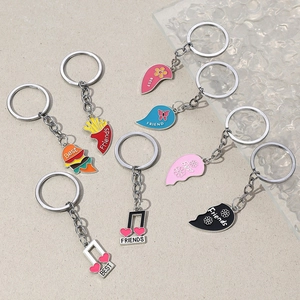 Colorful best friends heart and food metal keychains on a gray textured background