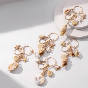 Creative ocean style shell and starfish keychain with acrylic conch charms on white stand