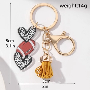 Detail of rugby keychain with leopard heart charms, yellow tassel, and size dimensions