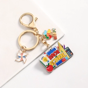 Back to School keychain with gold metal clasp, rainbow themed charms and stationery motifs