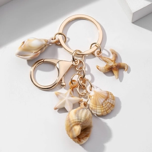 Creative marine theme keychain with resin starfish and shell charms on golden alloy ring
