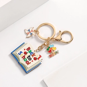 Detailed view of Back to School keychain with colorful book and apple charms