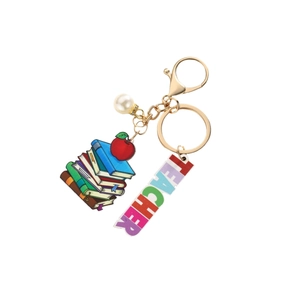 Colorful TEACHER keychain with stacked books, apple pendant and gold ring on white background
