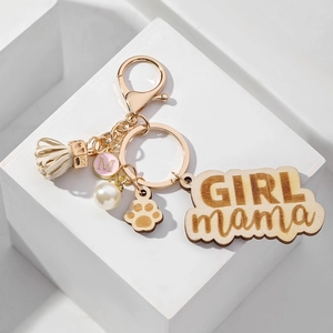 GIRL mama wooden keychain set with white tassel, pearl, and paw print charm on golden ring