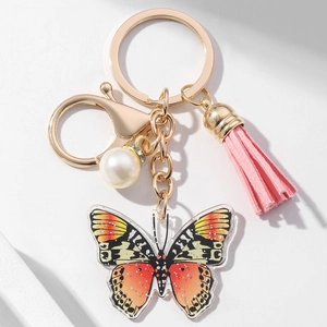 Colorful acrylic butterfly keychain with pink tassel, white pearl and golden ring