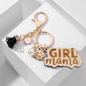 Custom wood GIRL mama keychain with pink M charm, black tassel, and white pearl accessory