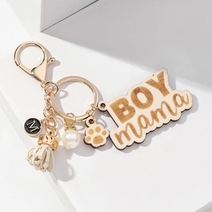 BOY MAMA wood keychain with white tassel, dog paw charm and pearl decoration