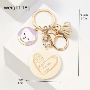 Detail view of Best Friends ever keychain with dog charm, beige tassel and size dimensions