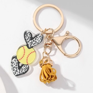 Detail of softball heart pendant with leopard print and yellow tassel on gold keychain