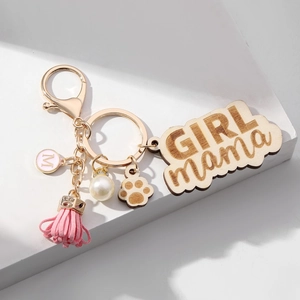 Detail view of GIRL MAMA wooden cloud charm with pink tassel and pearl keychain