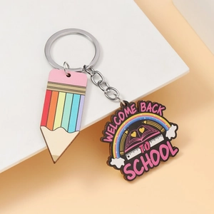 Rainbow pencil and School wood pendant keychain set on white geometric background