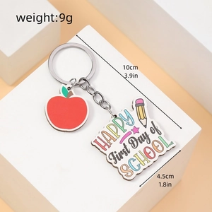 Detail of wooden apple keychain with Happy First Day of School text and dimensions