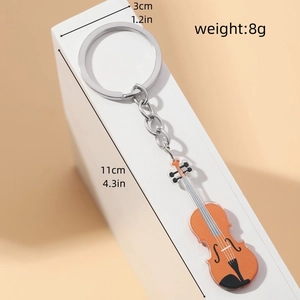 Detail view of acrylic violin keychain with dimensions and weight specs on beige stand
