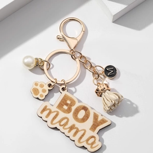 Golden keychain for BOY MAMA with wooden engraved tag, white pearl, and tassel