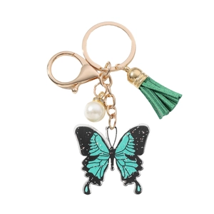 Acrylic butterfly keychain with teal glitter pendant, green tassel and white pearl charm