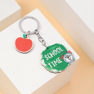Close-up of apple pendant and SCHOOL TIME charm on creative wooden keychain set