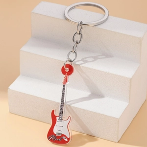 Acrylic electric guitar keychain with personalized Mark text on a white pedestal