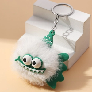 White fuzzy monster plush keychain with green silicone wings and soft decorative hat