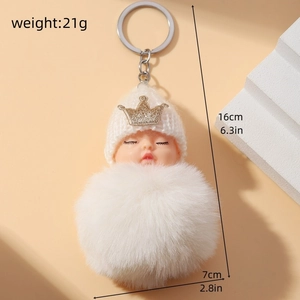 Detail view of plush baby keychain with crown hat showing dimensions 16x7cm and 21g weight