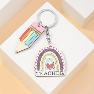 Macro shot of rainbow pencil and teacher heart charms on a wooden keychain pendant