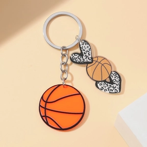 Detail shot of basketball keychain with leopard print heart charms and silver ring