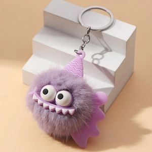 Detailed close-up of a purple plush monster keychain with silver metal clip and big eyes