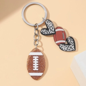 Macro shot of American football keychain with leopard heart and glitter brown charm