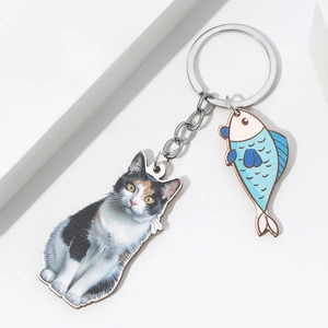 3D effect cat eating fish keychain featuring realistic calico cat and blue striped fish