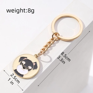 Detail view of cute black and white puppy keychain with precise size measurements in inches