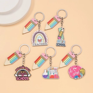 Detail of school theme acrylic keychains with rainbow pencils and teacher motifs