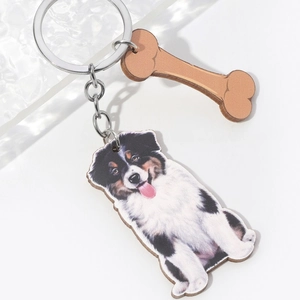 Detail of Australian Shepherd wooden keychain with a bone-shaped charm and silver ring