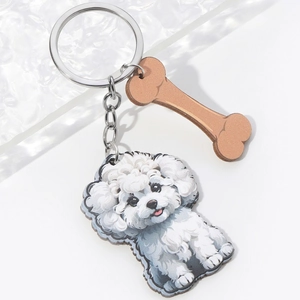 Detail of cute 3D cartoon white poodle keychain with bone charm and silver metal ring
