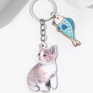 3D effect cat eating fish keychain with realistic grey kitten and blue cartoon fish charm