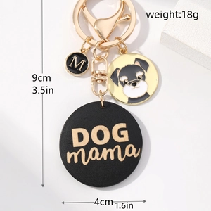Detailed close-up showing DOG MAMA wooden charm and Schnauzer dog pattern keychain