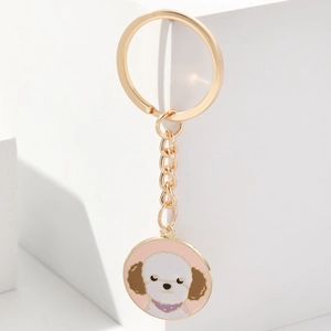 Cute puppy enamel keychain with golden metal ring on a minimalist white display