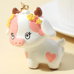 3D Cute Cartoon Cow Keychain with Pink Heart Patterns and Yellow Flower Detail