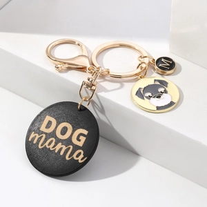 Detail of DOG MAMA wooden charm keychain with lobster clasp and metal dog pendant