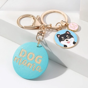 Detail of DOG MAMA pet keychain with husky charm and pink enamel letter M pendant