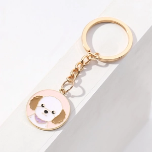 Cute poodle dog enamel keychain with light gold metal ring on a white minimalist background