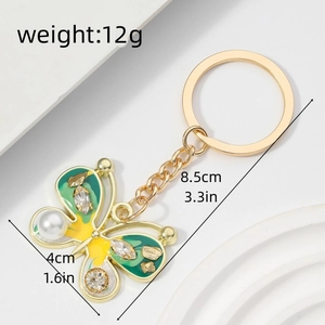 Detail view of colorful enamel butterfly keychain showing weight 12g and size 8.5x4cm