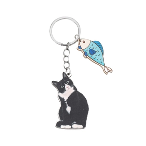 3D effect keychain featuring a cute black and white tuxedo cat and a blue fish pendant charm