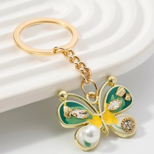 Enameled butterfly keychain with green wings, crystals and faux pearl drop pendant