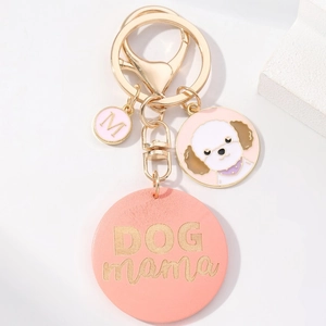 Pink Dog Mama wooden keychain with white poodle charm and gold fringe hardware