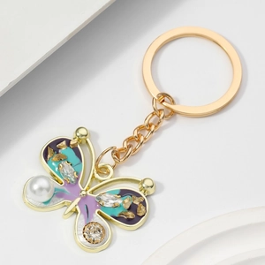 Elegant butterfly keychain with purple oil-drop wings and sparkling pearl in gold finish