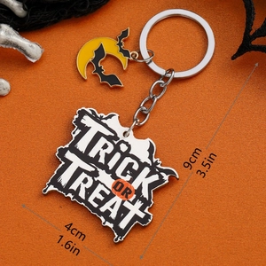 Detailed view of Halloween keychain with Trick or Treat text and pumpkin moon charms