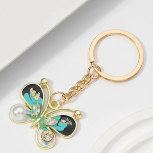 Exquisite gold alloy butterfly keychain with emerald enamel, sparkling rhinestones and pearl