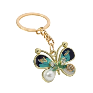 Elegant gold butterfly keychain with green enamel, sparkling rhinestones and a white pearl