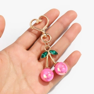 Cute pink pearl cherry keychain with golden heart clasp and green crystal leaves