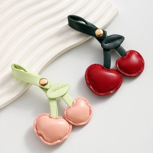 Creative heart shaped PU leather cherry keychain with gold ring and green leaf detail