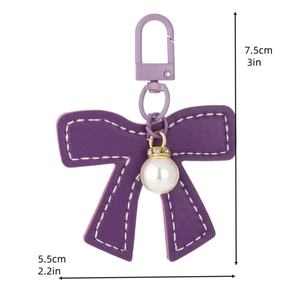 Purple leather bow keychain with pearl and diamonds, size 7.5cm x 5.5cm, on white background